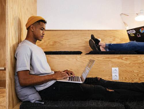 Person sitting on the floor with a laptop