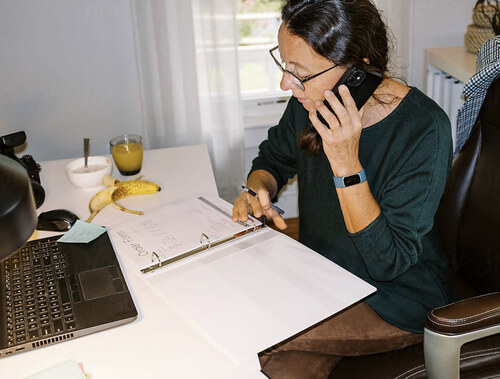 Person writing notes at a desk